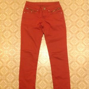 Orange skinny jeans with zippers